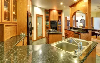 Beautiful new kitchen with wooden cabinets and newly installed granite countertops by Colorwheel Painting in Mequon