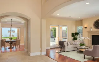 Large open-concept living and dining room with beautifully painted tan walls and ceilings