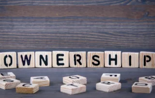 Tile letters spell out “ownership”