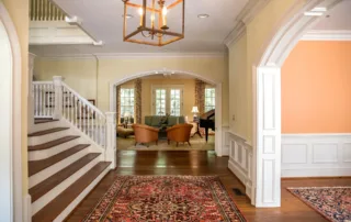 Ornate room with painted trim and wood stairs